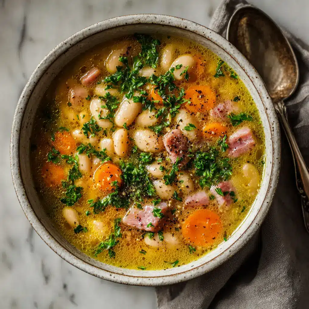 Slow Cooker Ham and Bean Soup (The Ultimate Comfort Food) 1 A close-up shot of slow cooker ham bone soup, showing tender beans and chunks of ham in a savory broth.