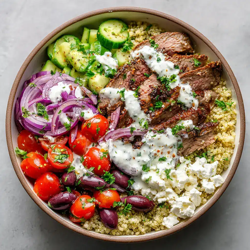 Overhead shot of a Mediterranean Steak Bowl drizzled with creamy tzatziki sauce and sprinkled with fresh parsley and dried oregano flakes.